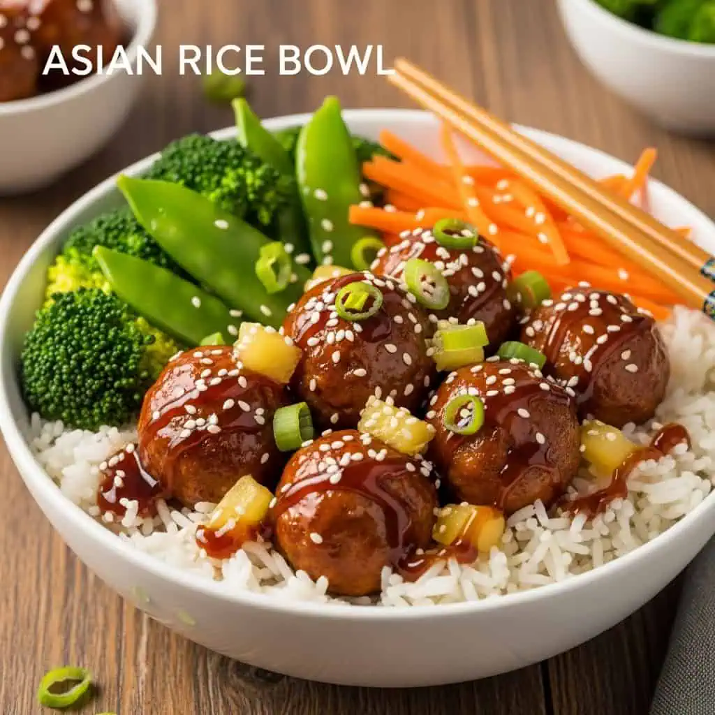 Amylu Teriyaki Pineapple meatballs served over jasmine rice with vegetables in Asian-style bowl with sesame seeds