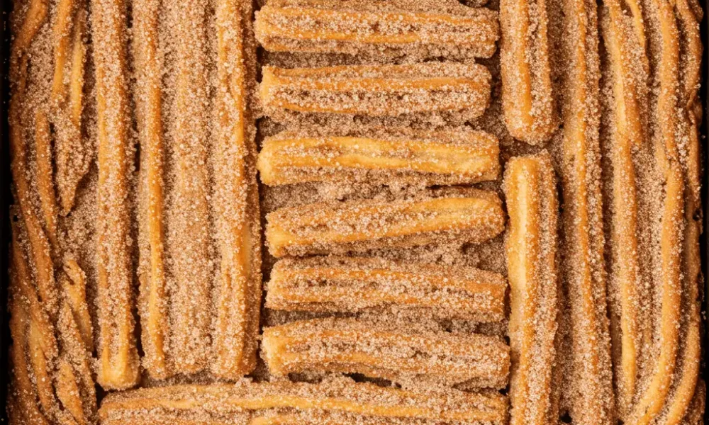 freshly baked churro bars recipe in cinnamon sugar crust